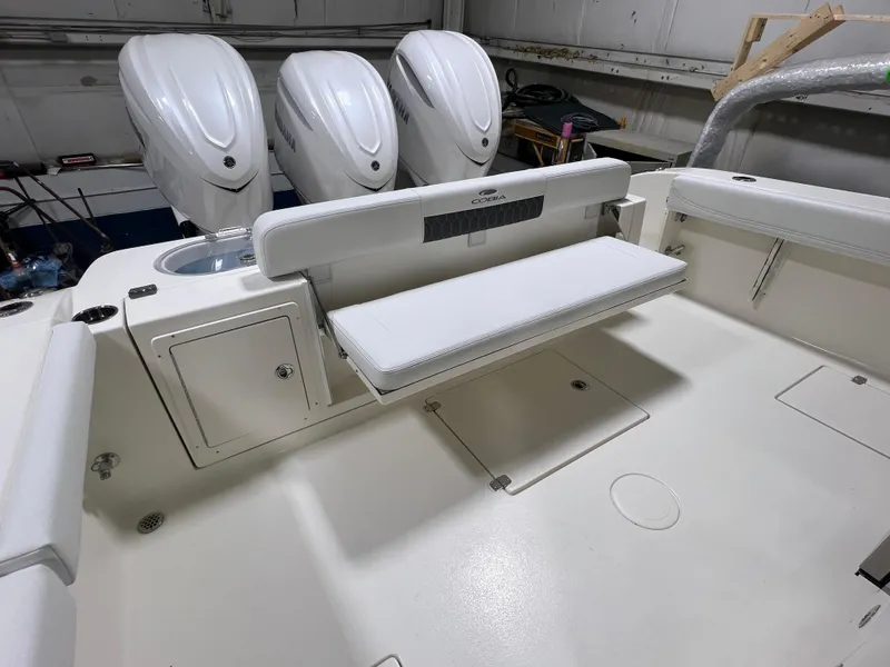 Slide: The Image of 2025 Cobia 350 Center Console boat interior with triple engines and foldable seating. - 5
