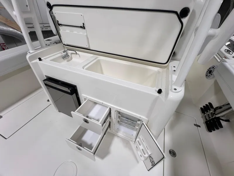 Slide: The Image of 2025 Cobia 350 Center Console boat with open storage compartments and sink. - 8