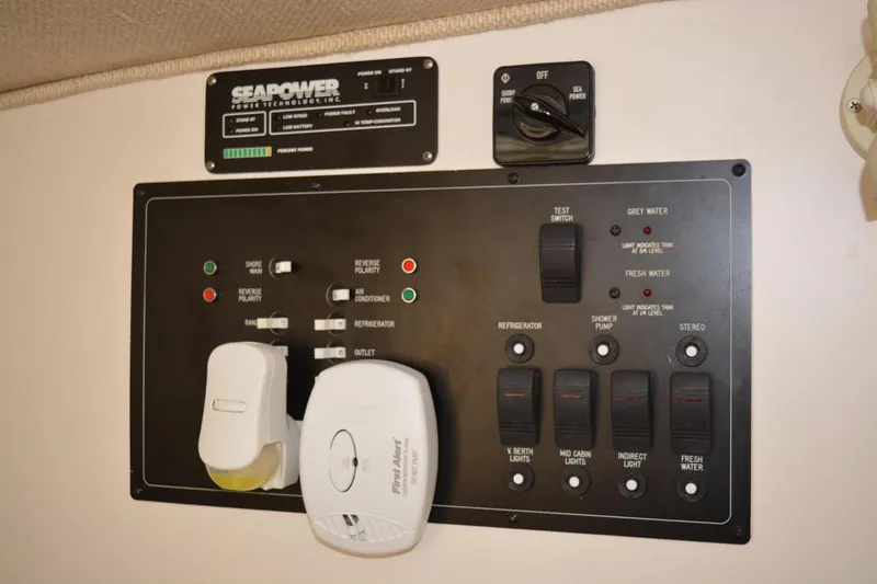 Slide: The Image of Control panel of a 1998 Rinker Fiesta Vee 280EC boat with various switches and indicators. - 14