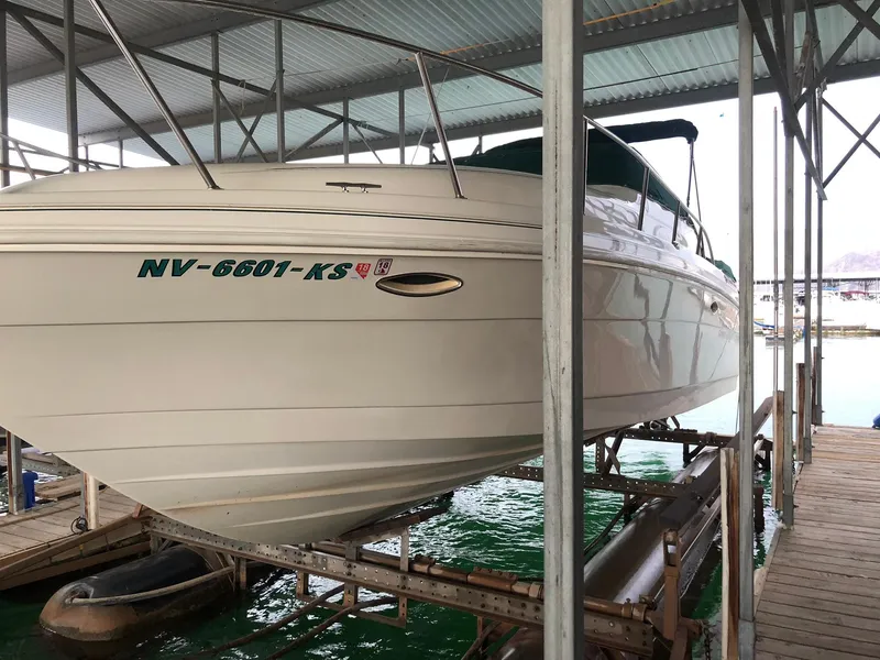 Slide: The Image of 1998 Rinker Fiesta Vee 280EC boat docked in a covered marina. - 3
