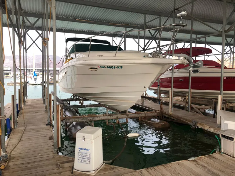 Slide: The Image of 1998 Rinker Fiesta Vee 280EC boat docked in a covered marina. - 5