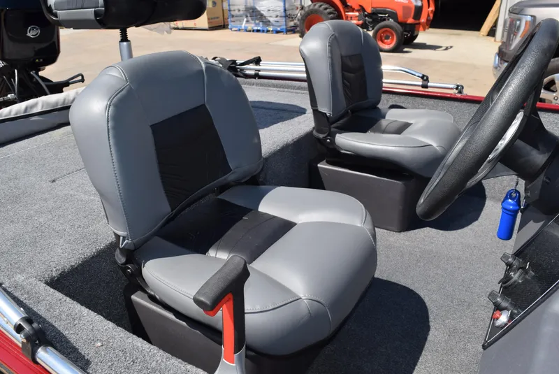 Slide: The Image of 2021 Tracker Bass Tracker Classic XL boat interior with gray seats and steering wheel. - 4
