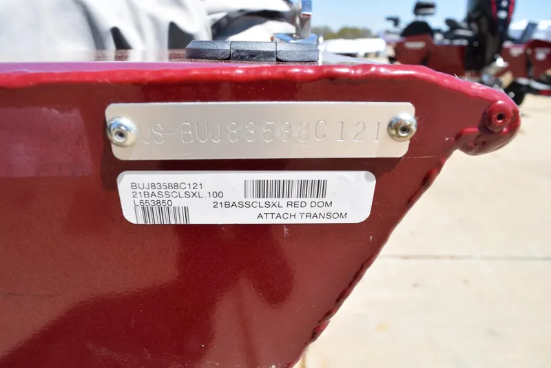 Slide: The Image of 2021 Tracker Bass Tracker Classic XL boat identification plate and label on red transom. - 8