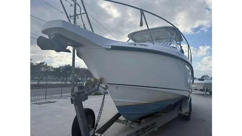 Slide: The Image of 2006 Boston Whaler 285 Conquest boat on trailer, cloudy sky background. - 6