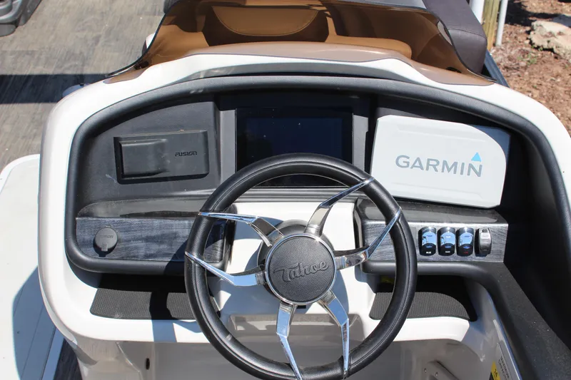 Slide: The Image of 2023 Tahoe Pontoon Cascade Platinum dashboard with Garmin display and sleek steering wheel. - 13