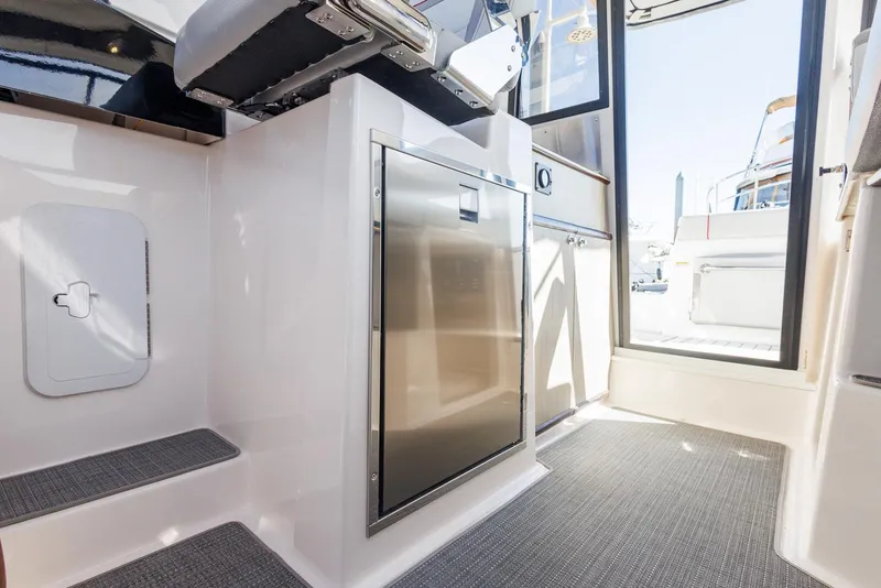 Slide: The Image of Interior of 2026 Solara 250-C boat with modern design and stainless steel appliances. - 13