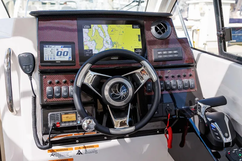 Slide: The Image of Helm of 2026 Solara 250-C boat with navigation screens and controls. - 5