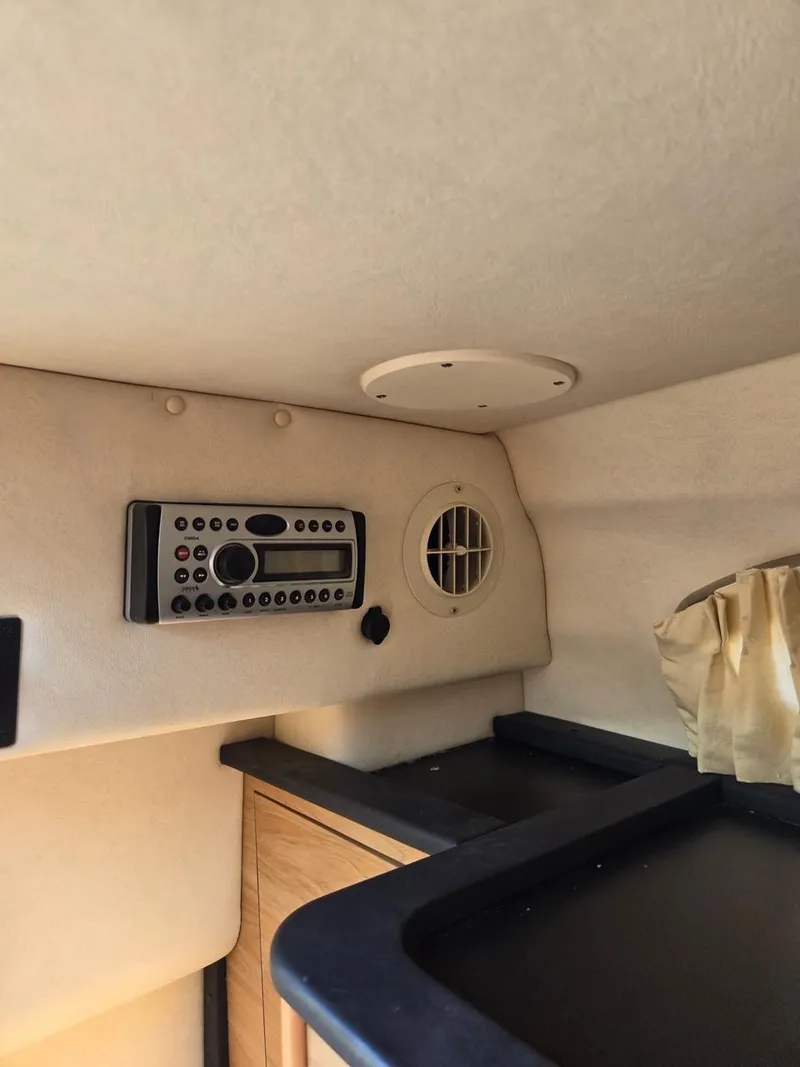 Slide: The Image of 2006 Sea Ray 270 Amberjack cabin interior with stereo system and ventilation. - 10