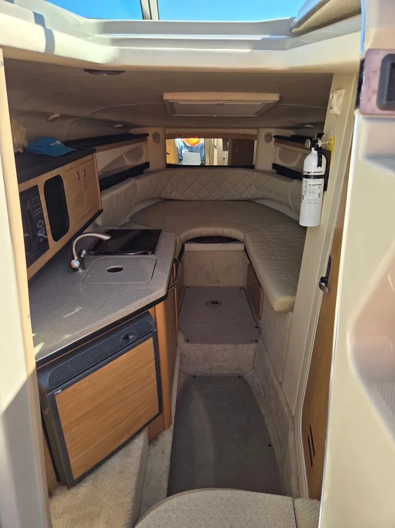 Slide: The Image of Interior of 2006 Sea Ray 270 Amberjack boat with kitchenette and seating area. - 11