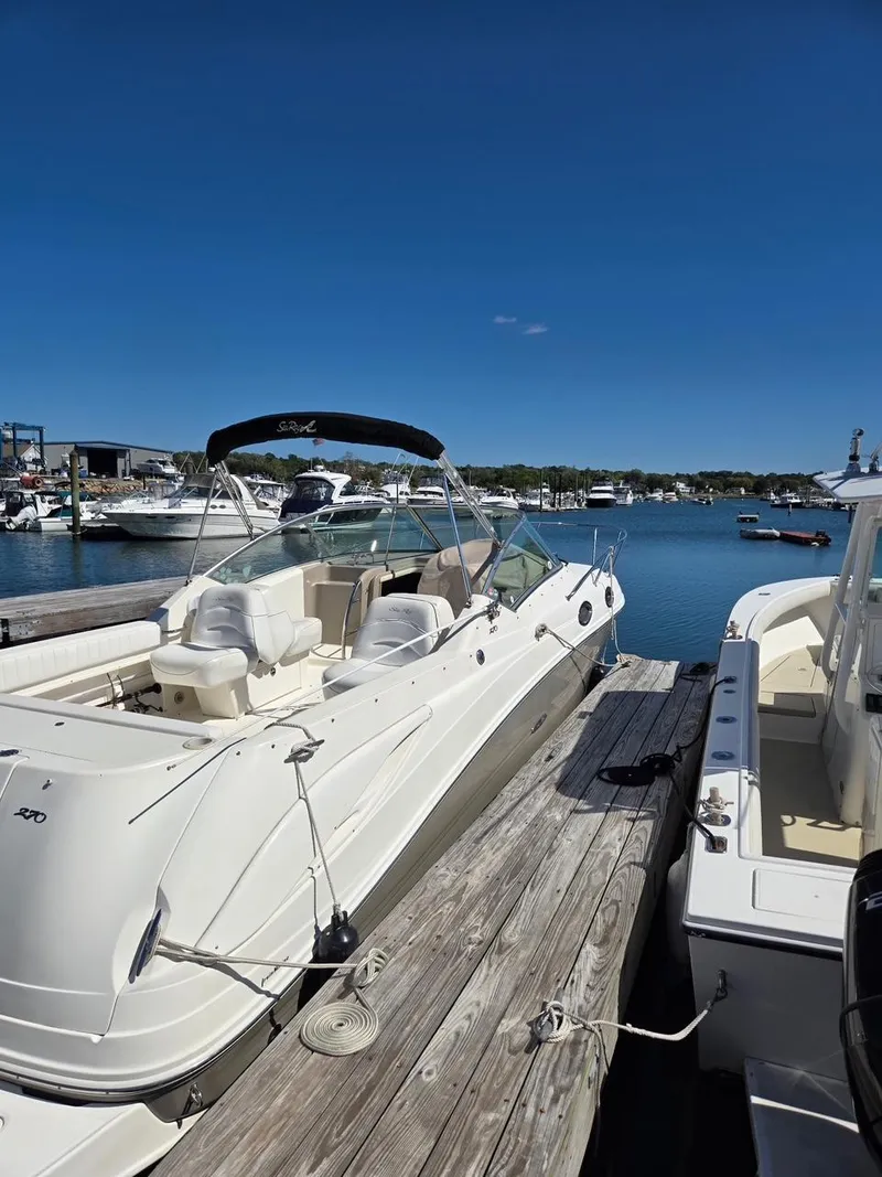 Slide: The Image of 2006 Sea Ray 270 Amberjack boat docked at a marina under clear blue skies. - 5