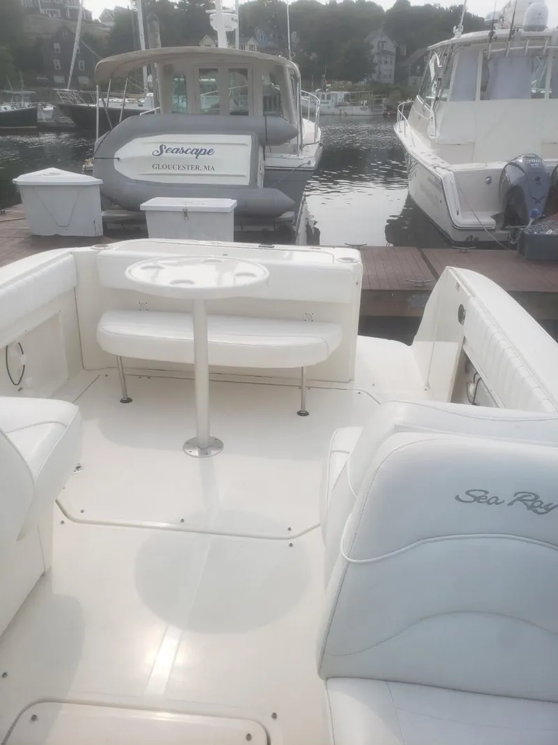Slide: The Image of 2006 Sea Ray 270 Amberjack boat with white seating, docked at a marina. - 6