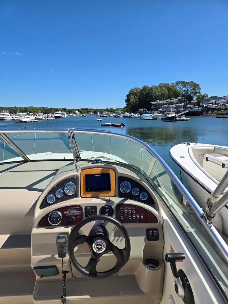 Slide: The Image of 2006 Sea Ray 270 Amberjack boat dashboard with marina view. - 8