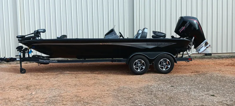 Slide: The Image of 2025 Ranger ALPHA 208 boat with dual-axle trailer, parked outdoors. - 1