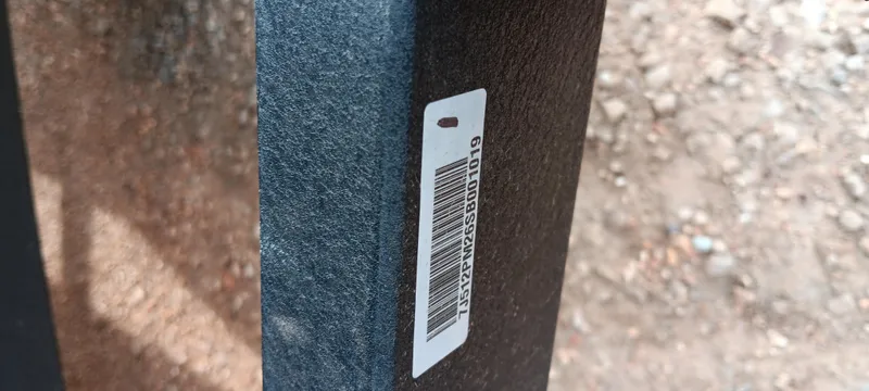 Slide: The Image of Barcode sticker on Ranger ALPHA 208, 2025 model, against textured surface. - 18