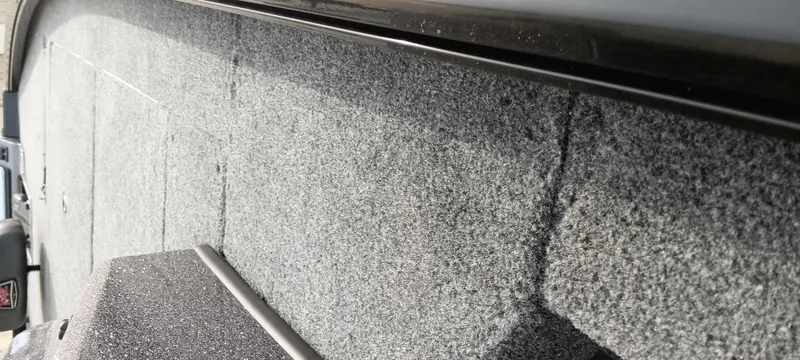 Slide: The Image of Carpeted interior of 2025 Ranger ALPHA 208 boat, showcasing textured flooring. - 2