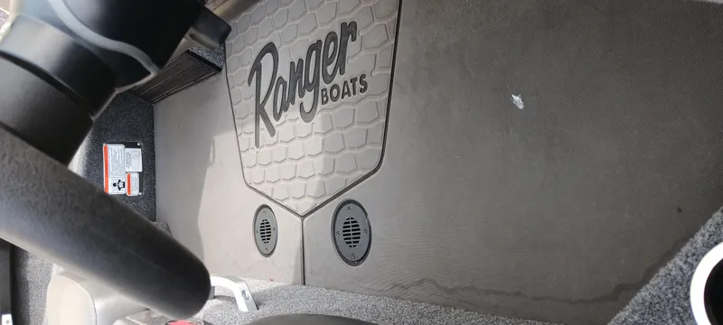Slide: The Image of Interior of 2025 Ranger ALPHA 208 boat with branded floor mat and speakers. - 3