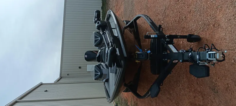 Slide: The Image of 2025 Ranger ALPHA 208 boat on trailer, parked on gravel near a metal building. - 4