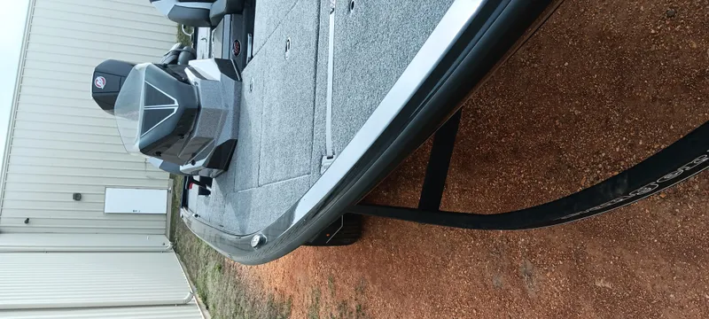 Slide: The Image of 2025 Ranger ALPHA 208 boat on trailer, parked near a building. - 5