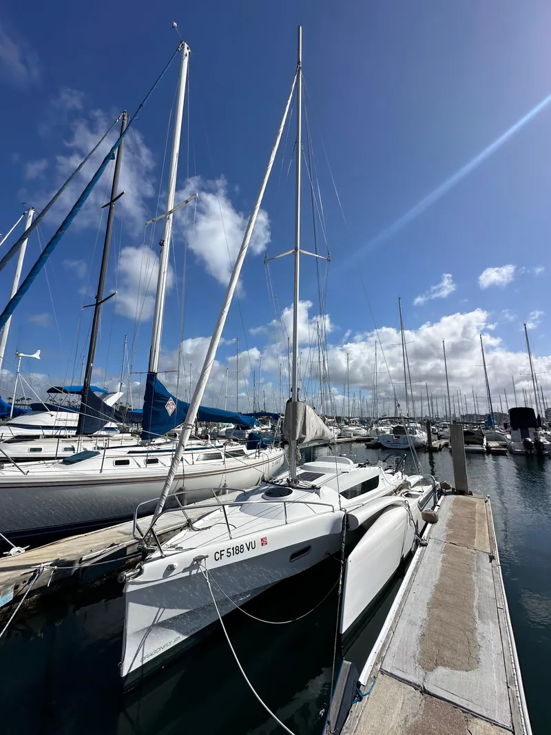 Slide: The Image of Sailboat docked at marina under blue sky, Dragonfly 25 Touring, 2021 model. - 10