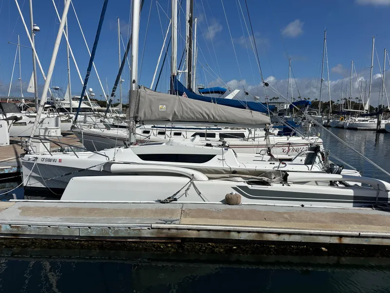 Slide: The Image of 2021 Dragonfly 25 Touring sailboat docked in a marina, surrounded by other boats. - 11