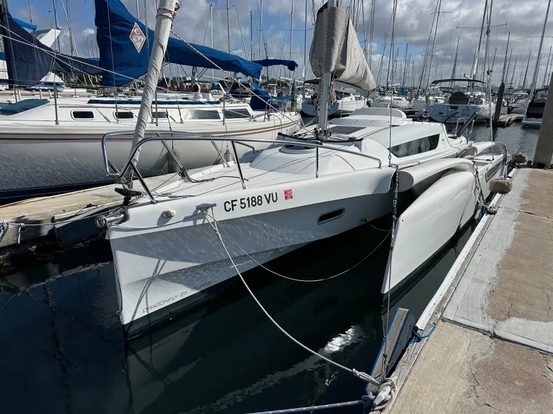 Slide: The Image of 2021 Dragonfly 25 Touring sailboat docked at a marina, featuring sleek design and white hull. - 12