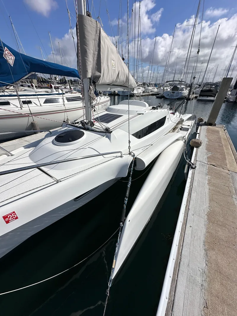 Slide: The Image of 2021 Dragonfly 25 Touring sailboat docked in a marina under a partly cloudy sky. - 15