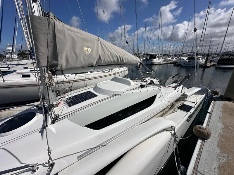Slide: The Image of 2021 Dragonfly 25 Touring sailboat docked in a marina under a clear blue sky. - 16