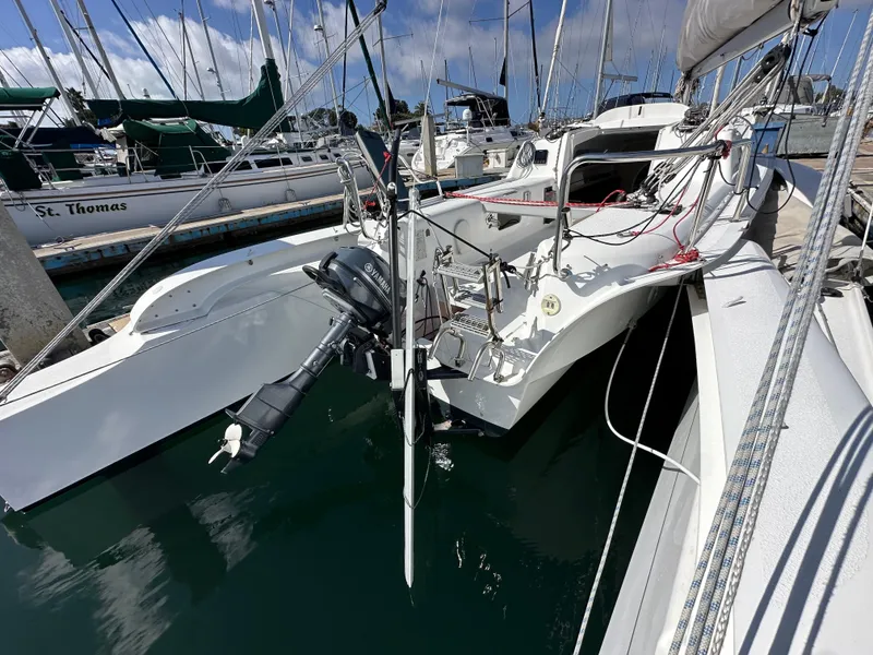 Slide: The Image of Sleek 2021 Dragonfly 25 Touring sailboat docked in marina, featuring modern design and outboard motor. - 21