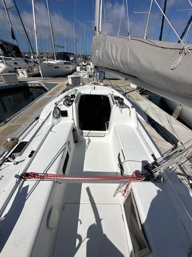 Slide: The Image of 2021 Dragonfly 25 Touring sailboat docked at marina, showcasing deck and rigging. - 22