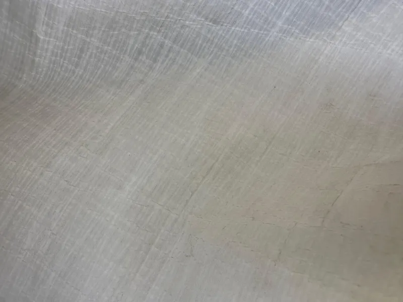 Slide: The Image of Close-up of Dragonfly 25 Touring 2021 boat's smooth, light-colored surface texture. - 32