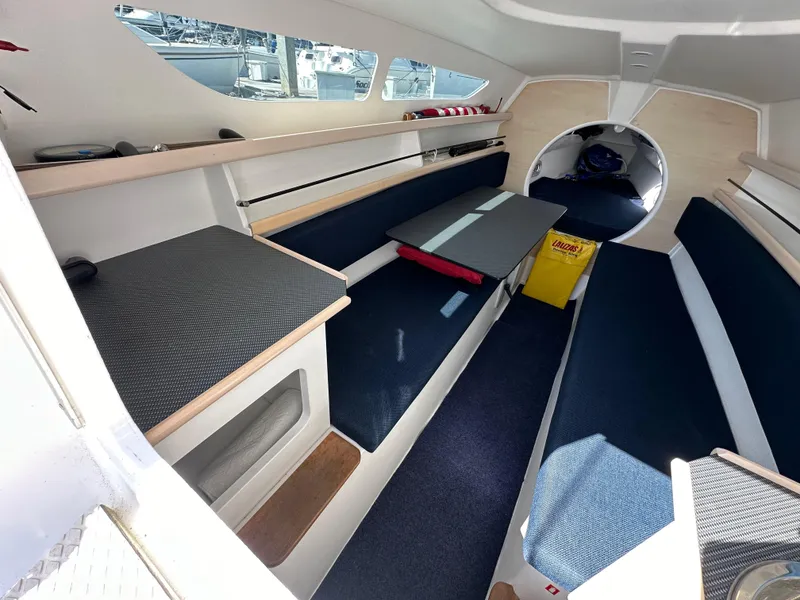 Slide: The Image of Interior of 2021 Dragonfly 25 Touring sailboat, featuring seating and table in a compact cabin. - 37