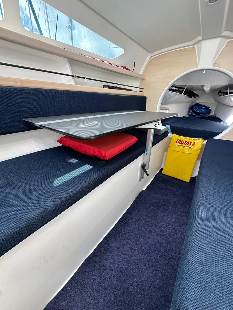 Slide: The Image of Interior of 2021 Dragonfly 25 Touring sailboat with blue seating and a foldable table. - 39