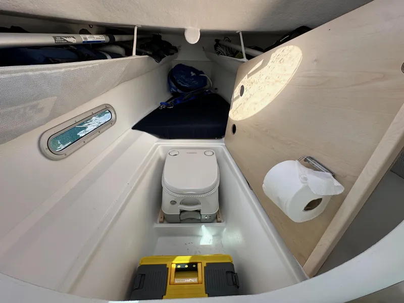 Slide: The Image of Compact cabin interior of 2021 Dragonfly 25 Touring with portable toilet and storage. - 41