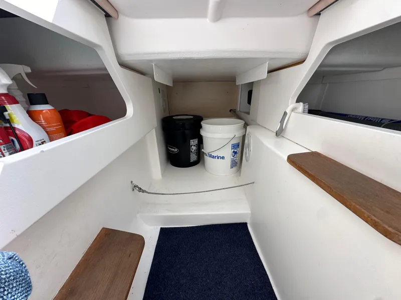 Slide: The Image of Interior of 2021 Dragonfly 25 Touring boat with storage shelves and cleaning supplies. - 47