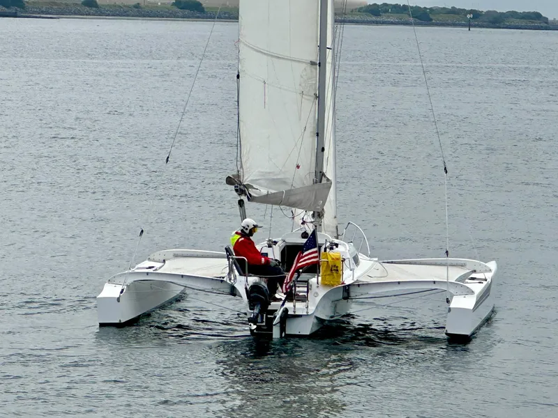 Slide: The Image of Sailboat Dragonfly 25 Touring 2021 on calm water with American flag. - 6