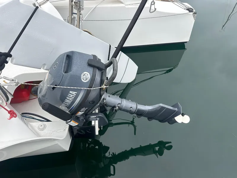 Slide: The Image of Outboard motor on a 2021 Dragonfly 25 Touring sailboat, docked on calm water. - 7