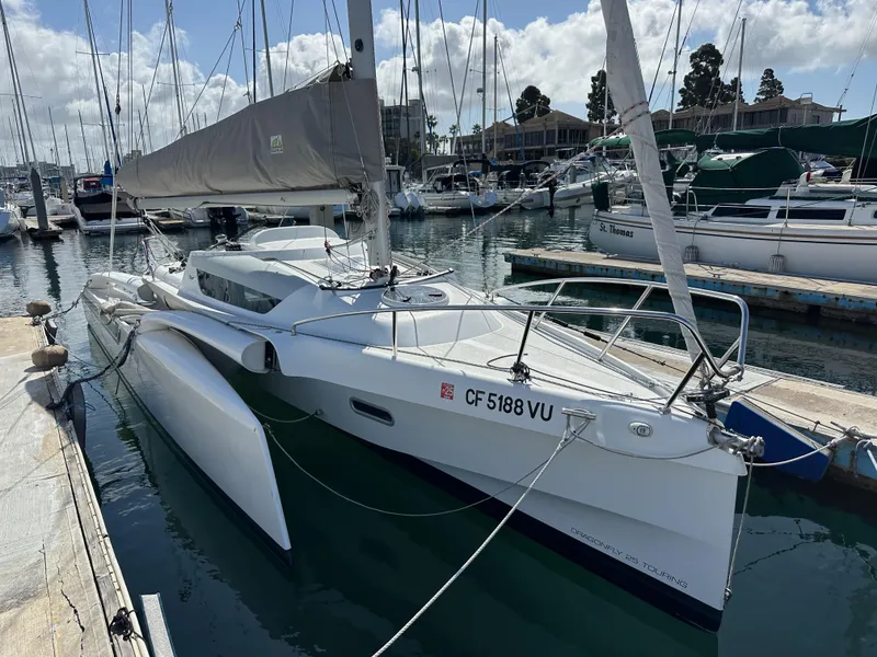 Slide: The Image of 2021 Dragonfly 25 Touring sailboat docked in a marina under a partly cloudy sky. - 8