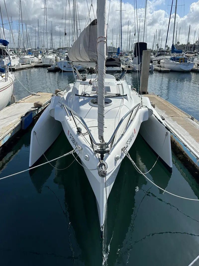 Slide: The Image of 2021 Dragonfly 25 Touring sailboat docked in a marina, surrounded by other boats. - 9
