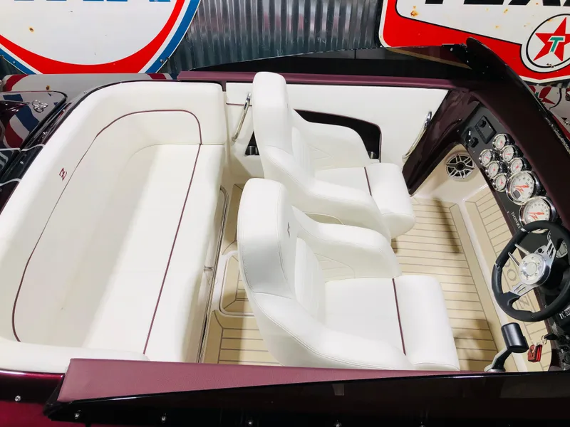 Slide: The Image of 2022 Donzi Classic boat interior with white seating and modern dashboard. - 4