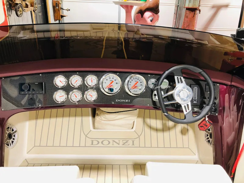 Slide: The Image of 2022 Donzi Classic dashboard with gauges and steering wheel in a sleek design. - 6