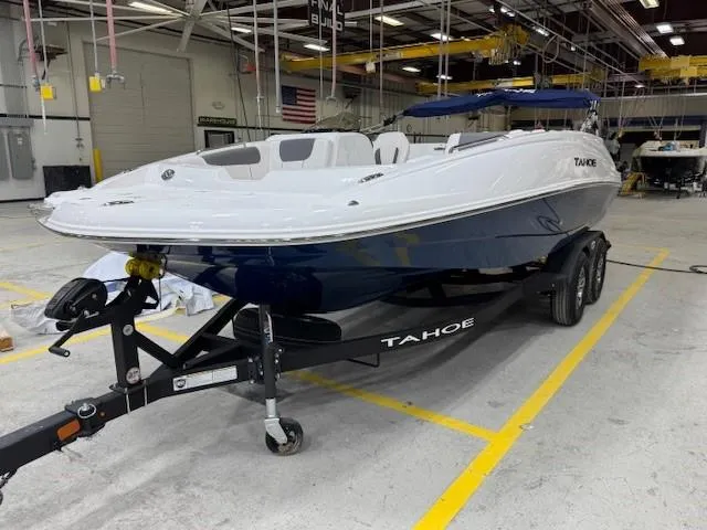 Slide: The Image of 2024 Tahoe 1950 boat on trailer in a warehouse setting. - 1