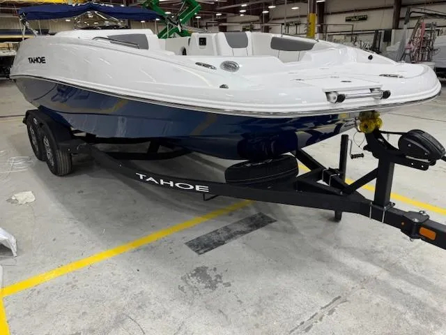 Slide: The Image of 2024 Tahoe 1950 boat on trailer in warehouse setting. - 2