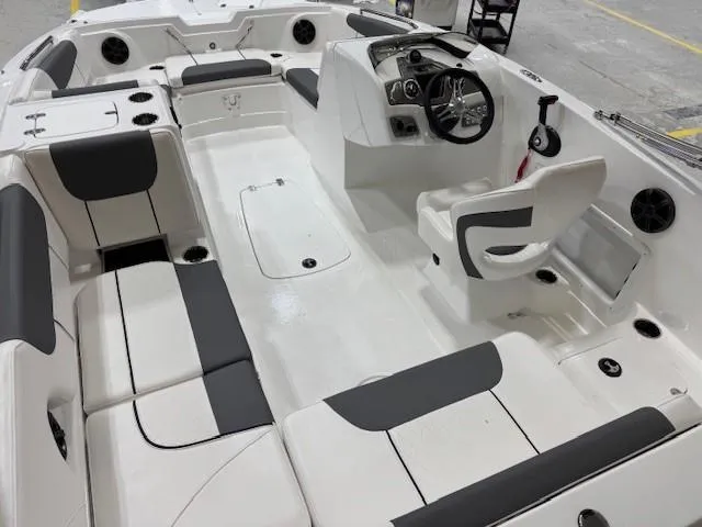 Slide: The Image of 2024 Tahoe 1950 boat interior with white and gray seating, steering console, and spacious layout. - 4