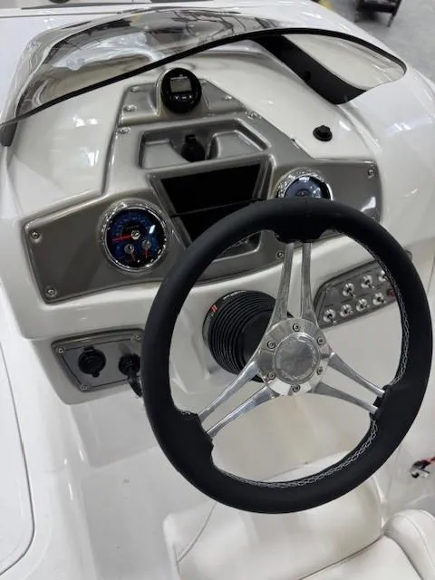 Slide: The Image of Steering console of a 2024 Tahoe 1950 boat with modern controls and gauges. - 5