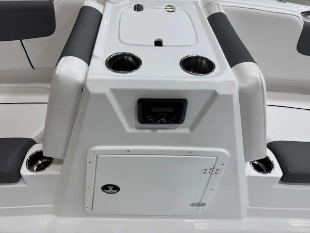 Slide: The Image of 2024 Tahoe 1950 boat interior with seating, cup holders, and storage compartment. - 7