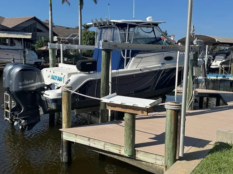 Slide: The Image of 2012 Robalo R265 Walkaround boat docked with Yamaha outboard motor. - 6