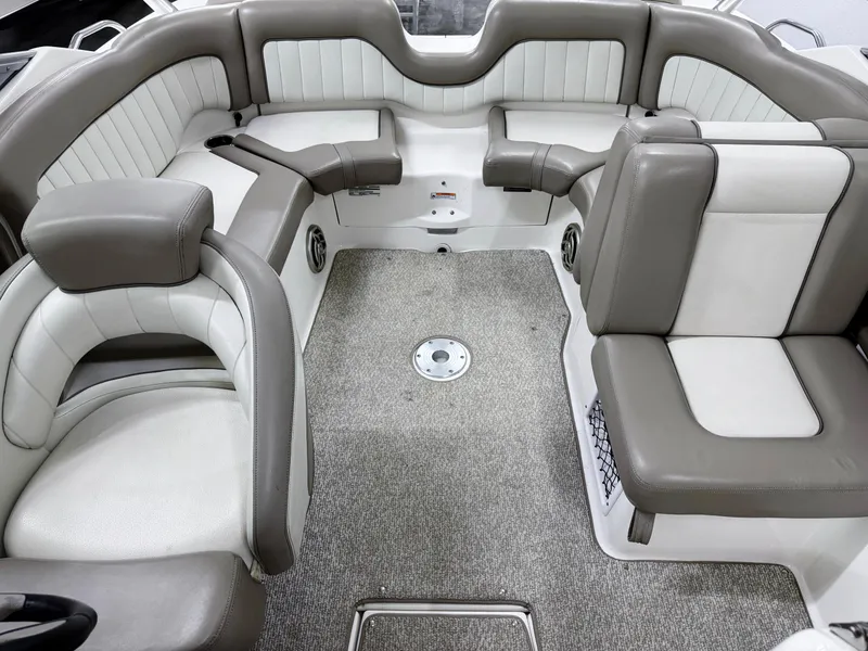 Slide: The Image of 2009 Yamaha Boats 232 Limited S interior with gray and white seating, carpeted floor. - 10