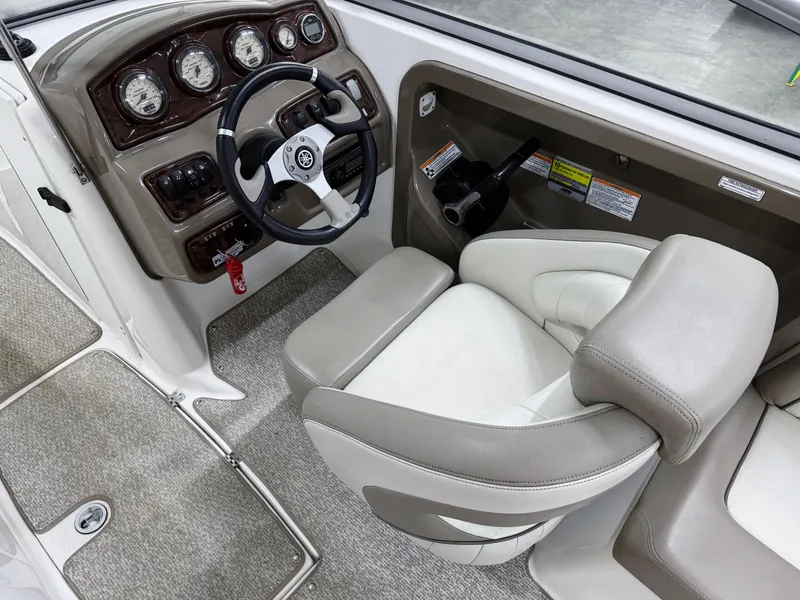 Slide: The Image of 2009 Yamaha Boats 232 Limited S cockpit with steering wheel and gauges. - 13