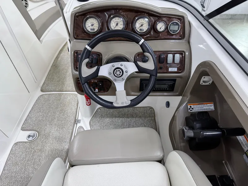 Slide: The Image of 2009 Yamaha Boats 232 Limited S dashboard with steering wheel and instrument panel. - 14