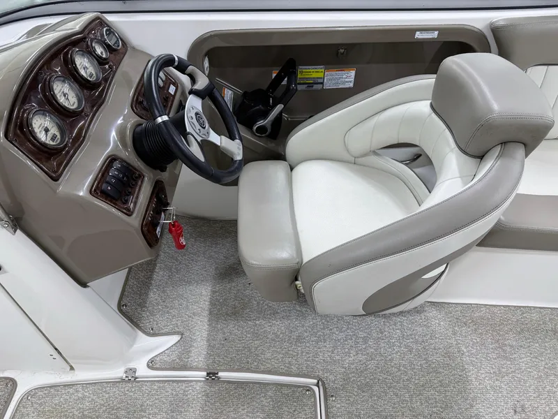 Slide: The Image of 2009 Yamaha Boats 232 Limited S cockpit with steering wheel and plush seating. - 15